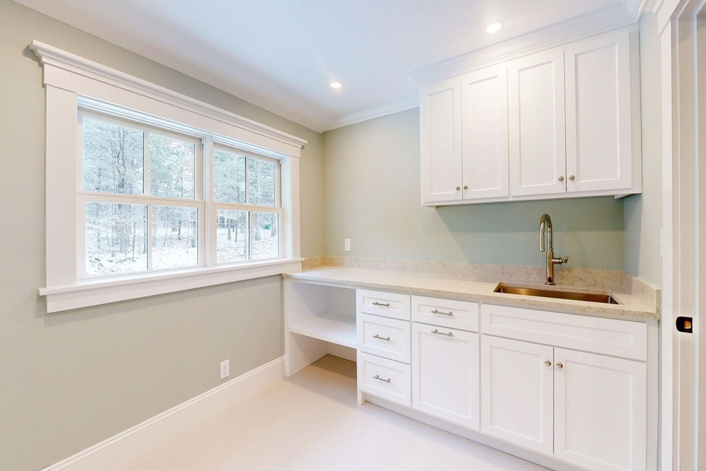 298 Summer Street Westwood, MA 02090 - Photo 16 of 24 a kitchen with white cabinets and a window