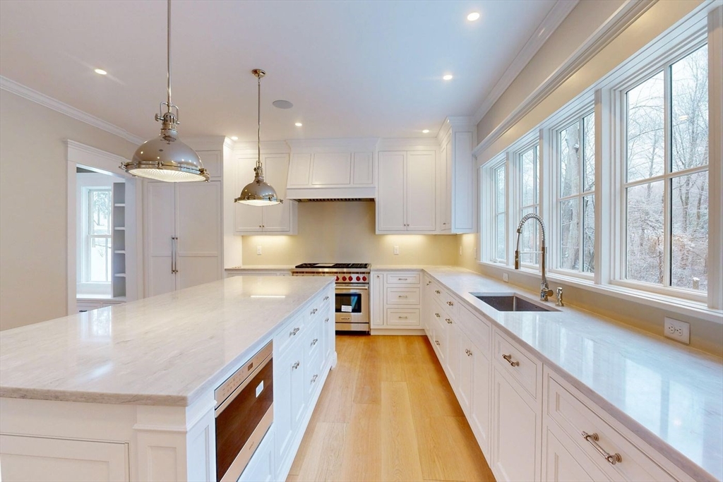 298 Summer Street Westwood, MA 02090 - Photo 4 of 24 a large kitchen with kitchen island a large counter space a sink appliances and a large window