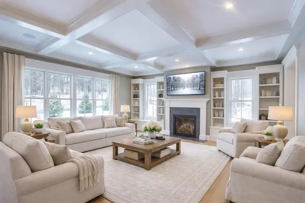 a living room with furniture fireplace and a large window