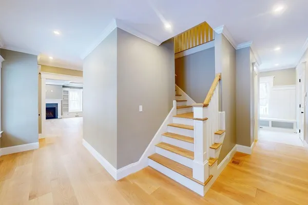 a view of entryway with furniture and wooden floor