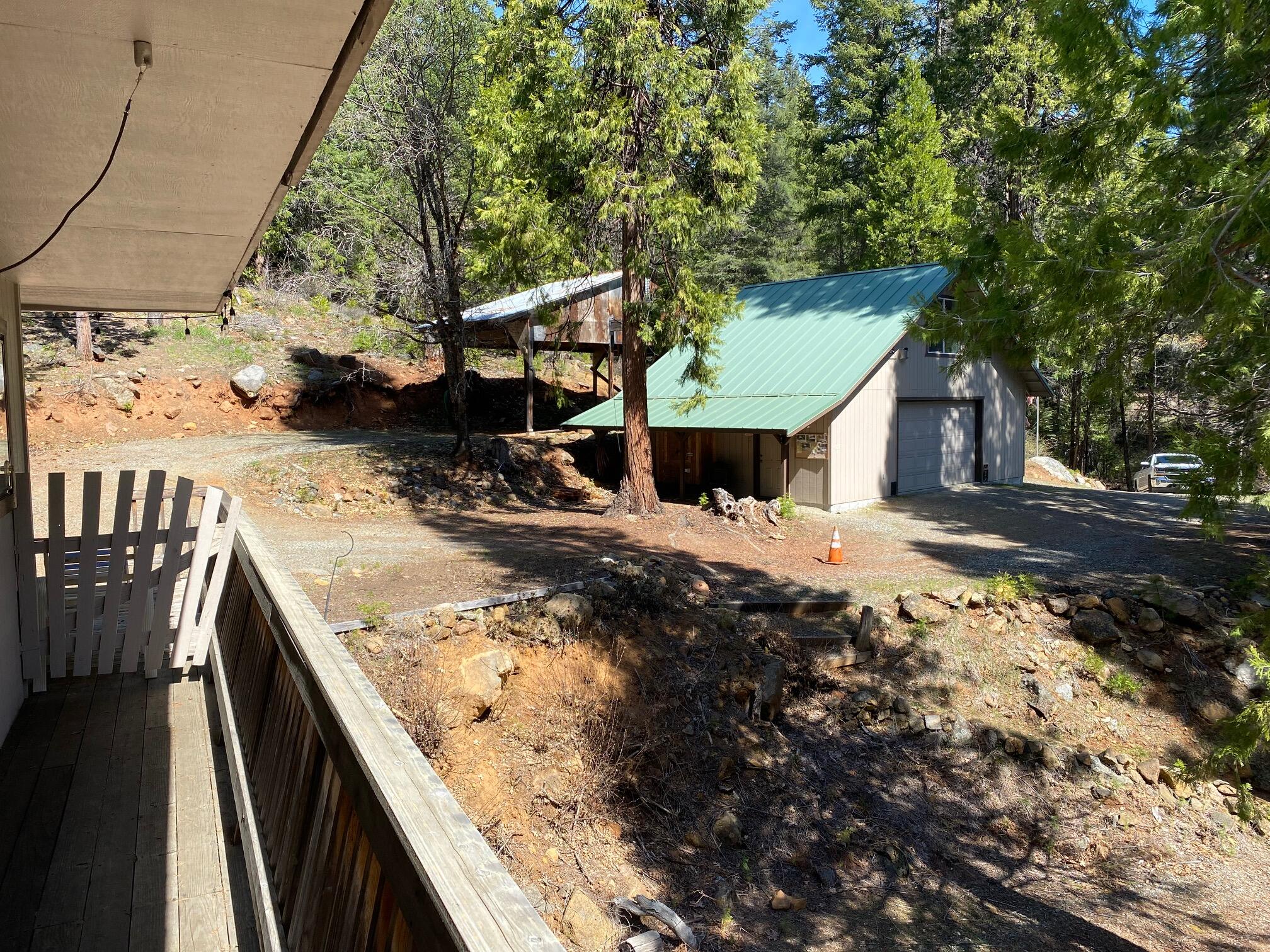 581 Mountain Aire Road Trinity Center, CA 96091 - Photo 29 of 48 Side deck of main house with garage seen in the rear of the pic