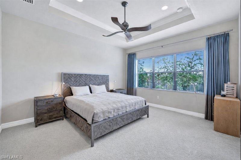 3407 Baltic Drive Naples, FL 34119 - Photo 14 of 31 a spacious bedroom with a bed and large window