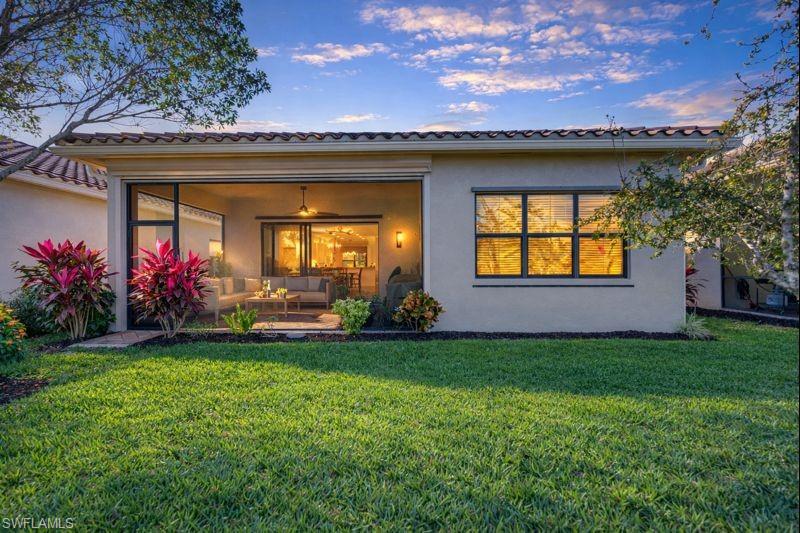 3407 Baltic Drive Naples, FL 34119 - Photo 20 of 31 a view of a house with a garden