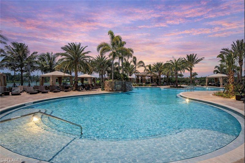 3407 Baltic Drive Naples, FL 34119 - Photo 29 of 31 a swimming pool with outdoor seating and yard
