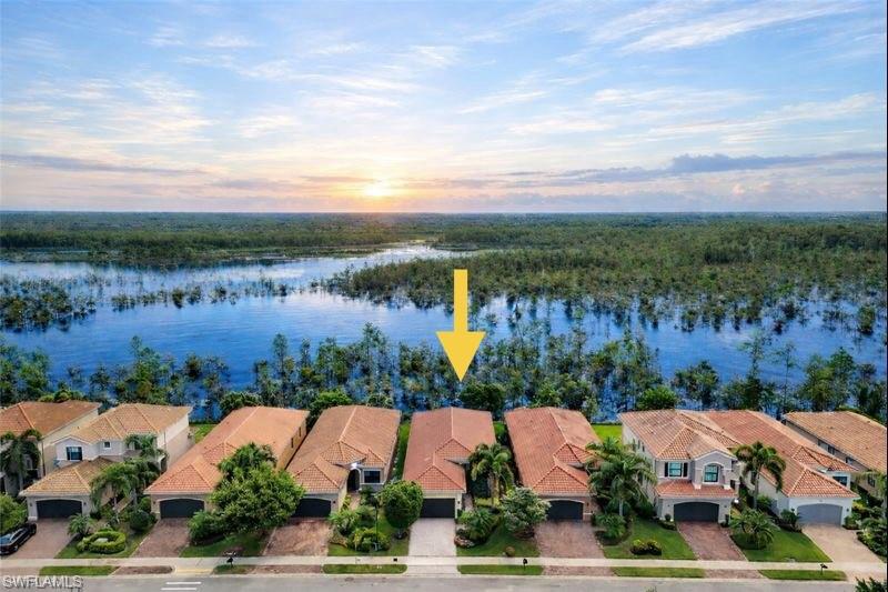 3407 Baltic Drive Naples, FL 34119 - Photo 30 of 31 Aerial view at dusk of a water view and a residential view