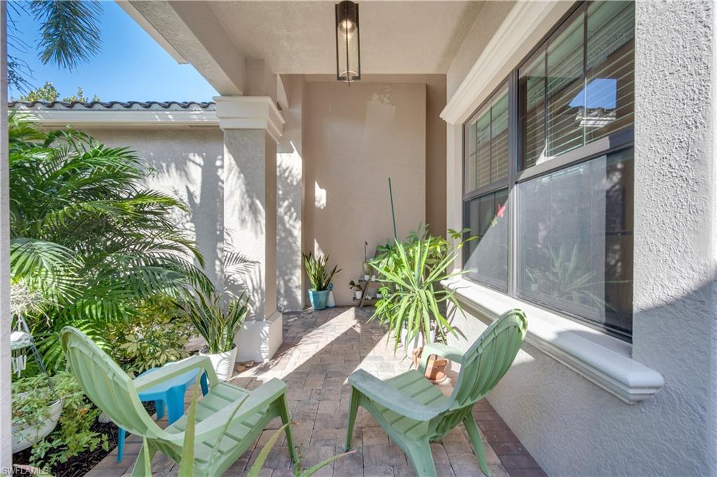 3407 Baltic Drive Naples, FL 34119 - Photo 5 of 31 a potted plant sitting in front of a door