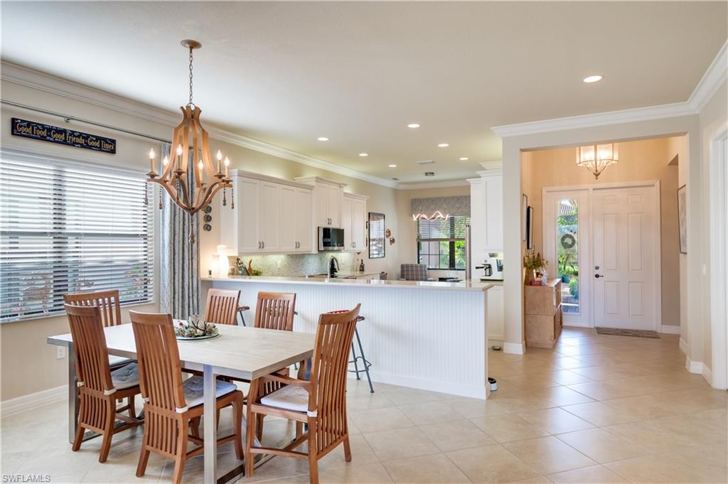 3407 Baltic Drive Naples, FL 34119 - Photo 6 of 31 a view of a dining room and livingroom with furniture wooden floor a chandelier