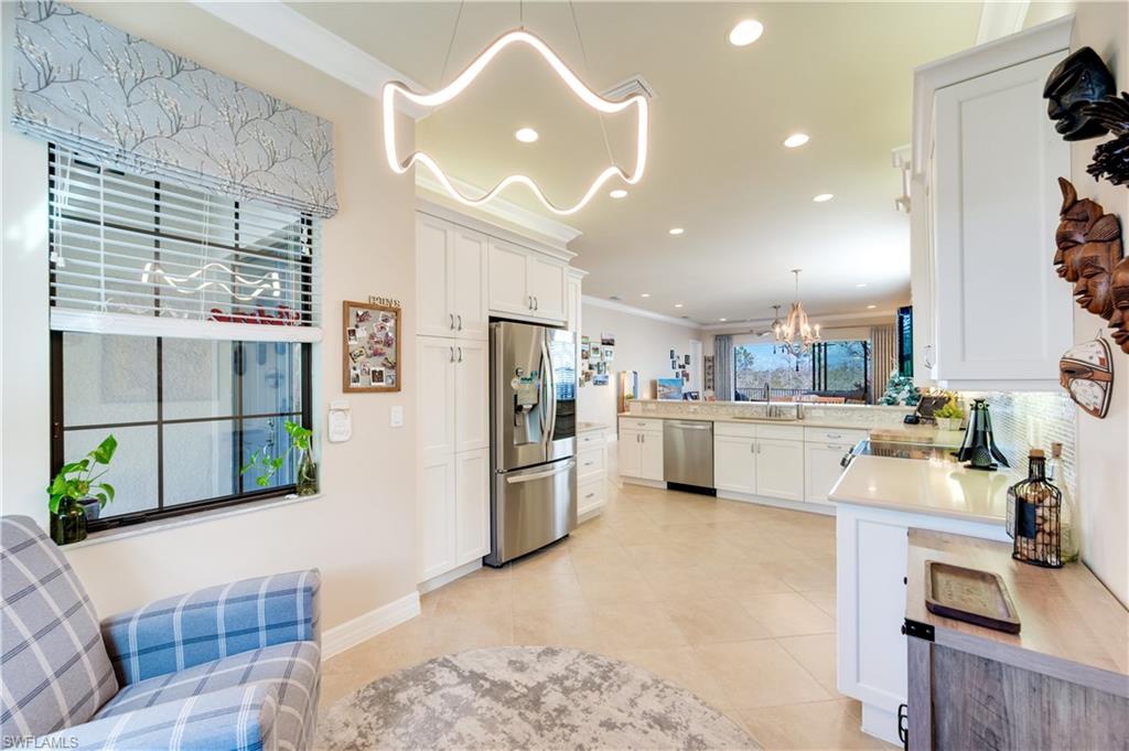 3407 Baltic Drive Naples, FL 34119 - Photo 10 of 31 a kitchen with refrigerator and cabinets