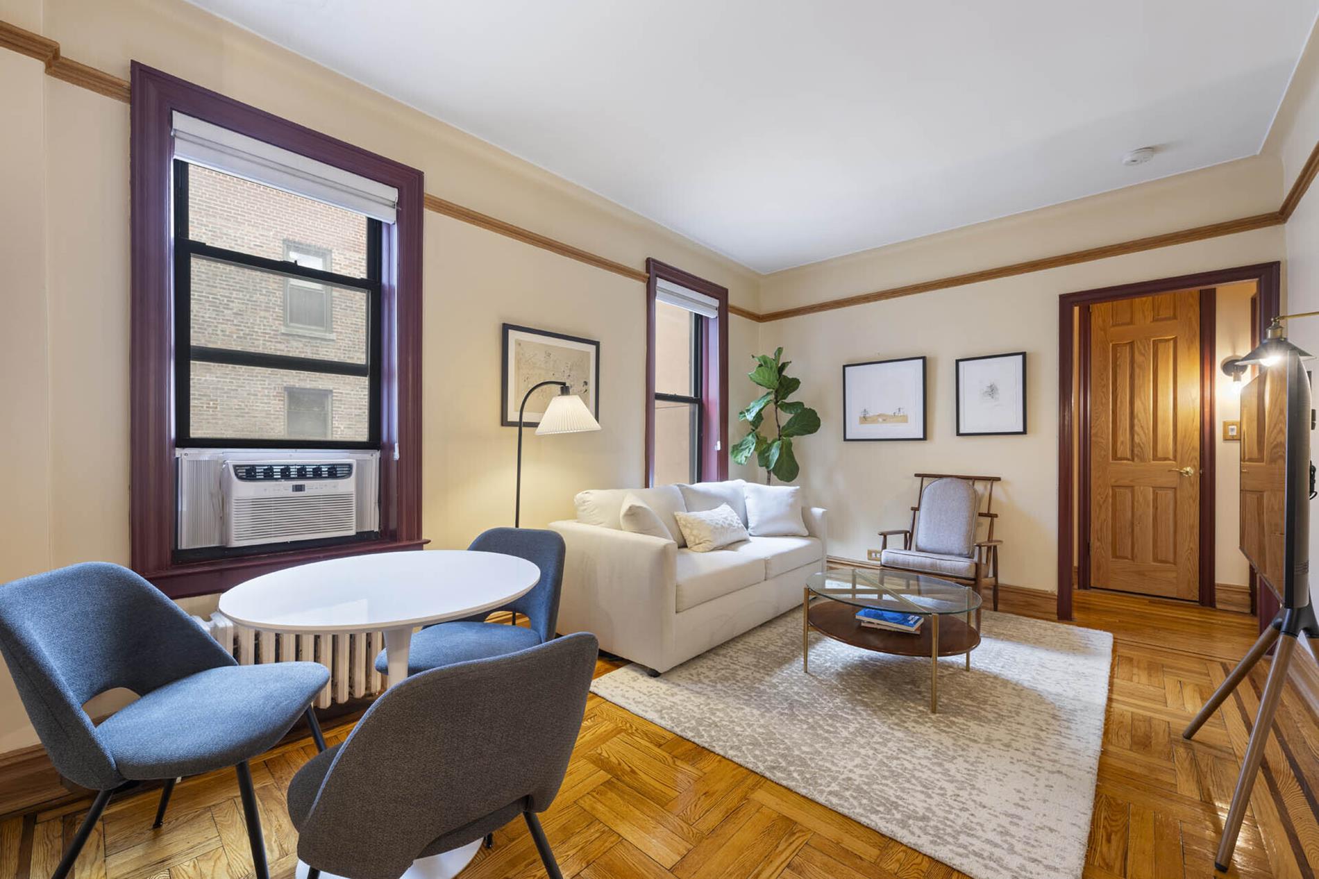 170 East 94th Street, Unit 5E Manhattan, NY 10128 - Photo 2 of 8 a living room with furniture and a window