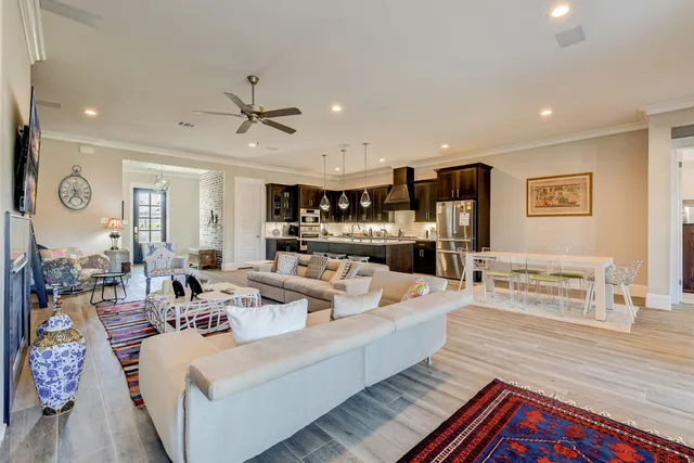 a living room with furniture a flat screen tv and a fireplace