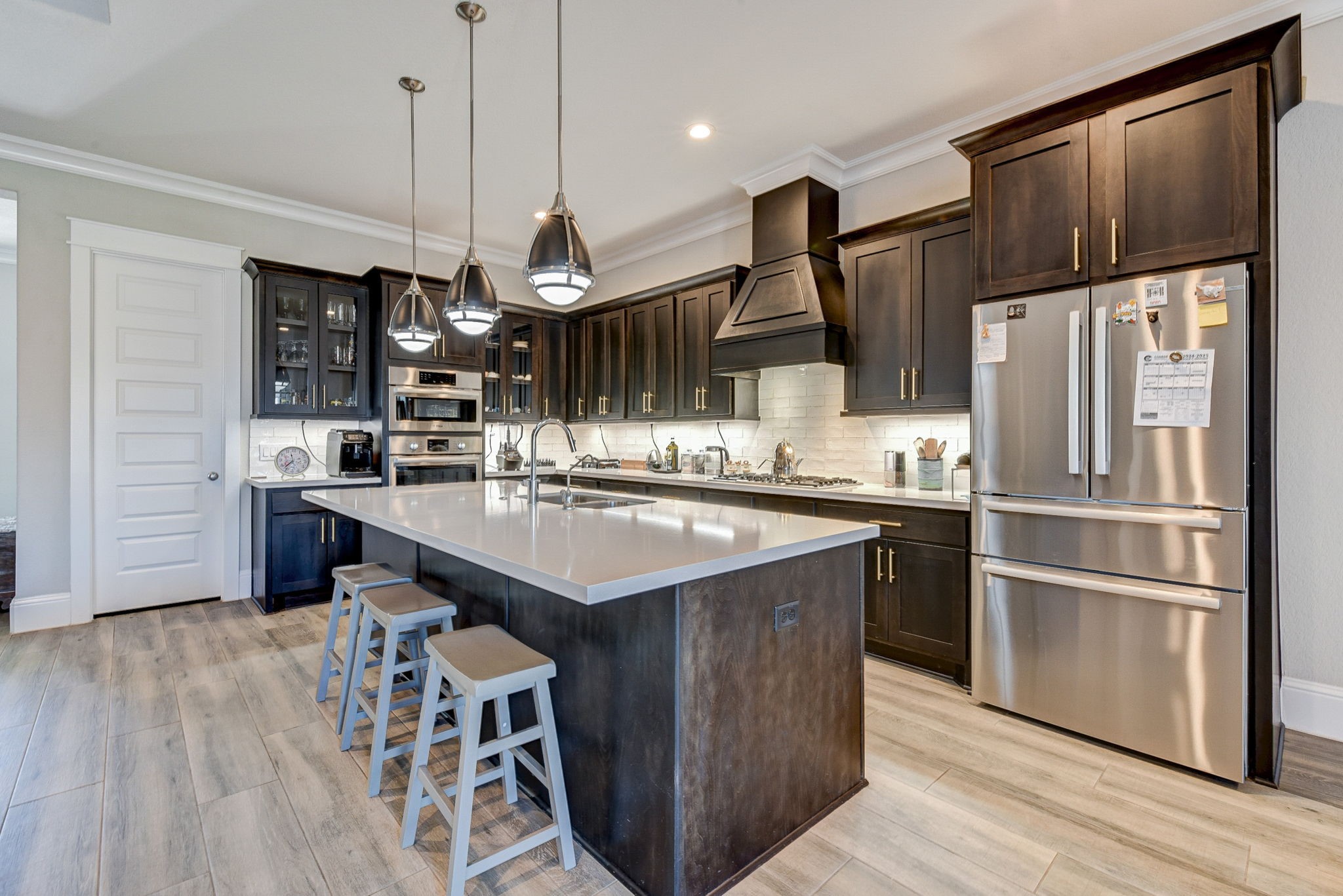 2339 Pale Star Drive Conroe, TX 77384 - Photo 17 of 43 a kitchen with kitchen island granite countertop a sink appliances and cabinets