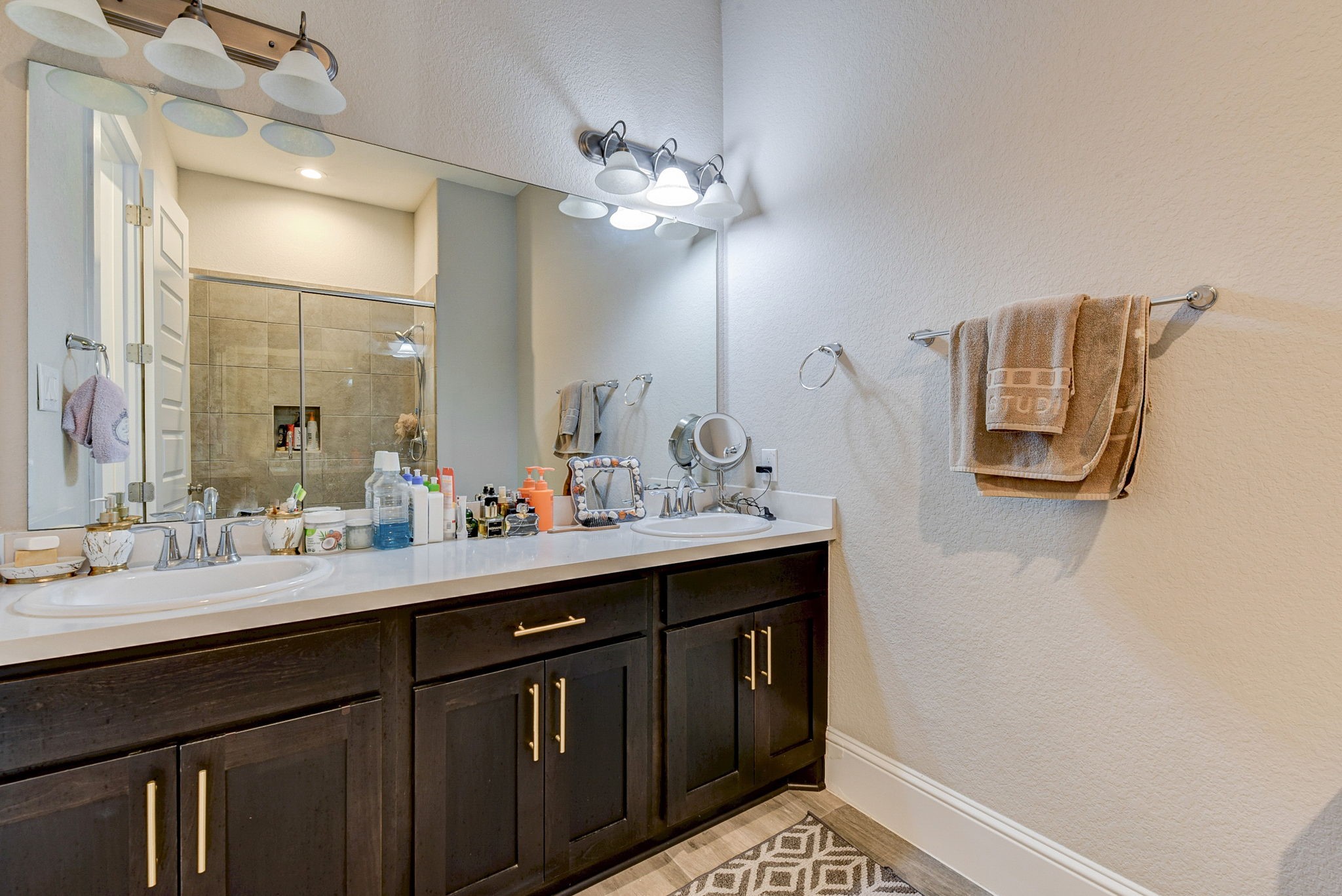 2339 Pale Star Drive Conroe, TX 77384 - Photo 35 of 43 a bathroom with a sink a light fixture and a mirror
