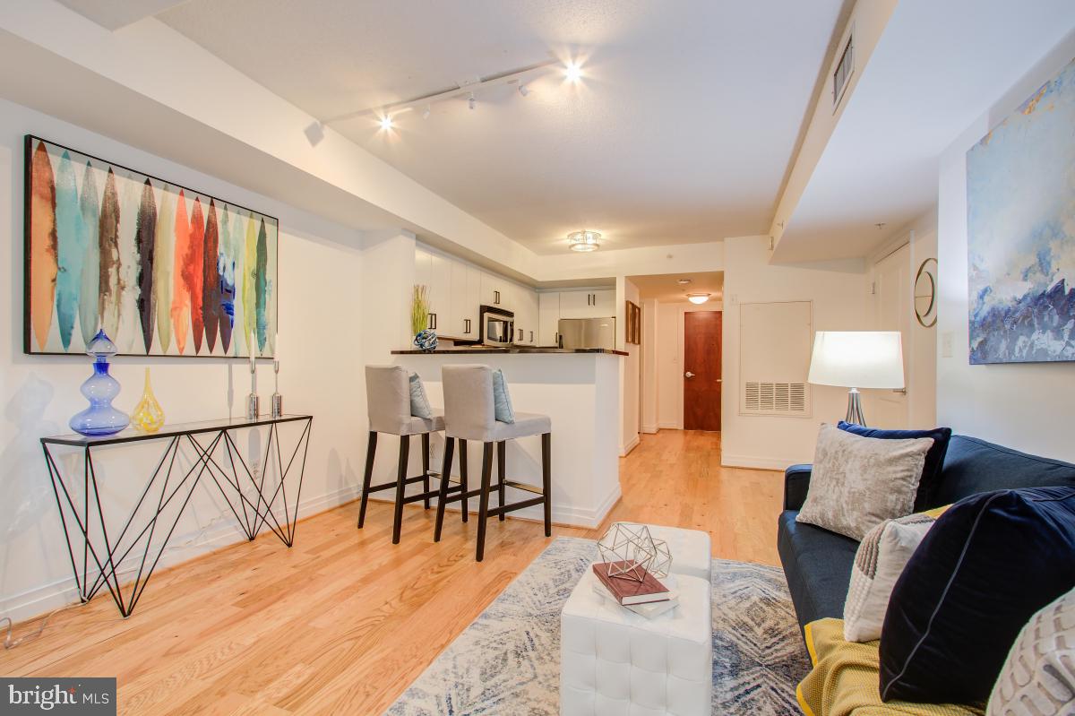 915 E Street Northwest, Unit 101 Washington, DC 20004 - Photo 2 of 34 a living room with furniture and a large window