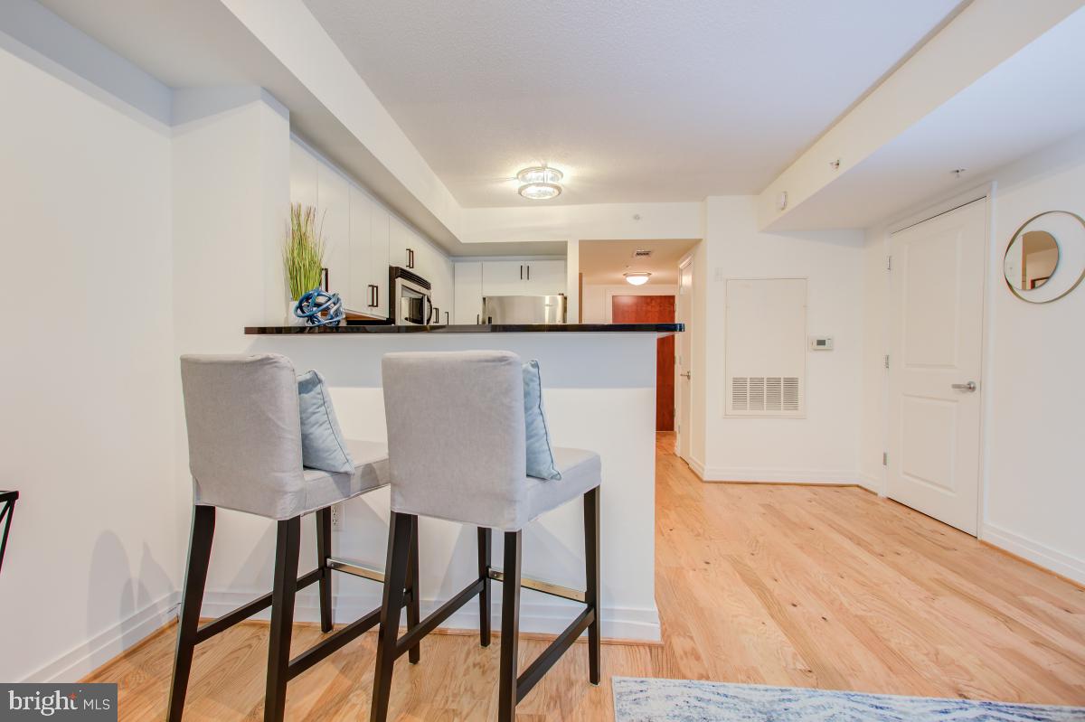 915 E Street Northwest, Unit 101 Washington, DC 20004 - Photo 18 of 34 a view of a dining room with furniture and wooden floor