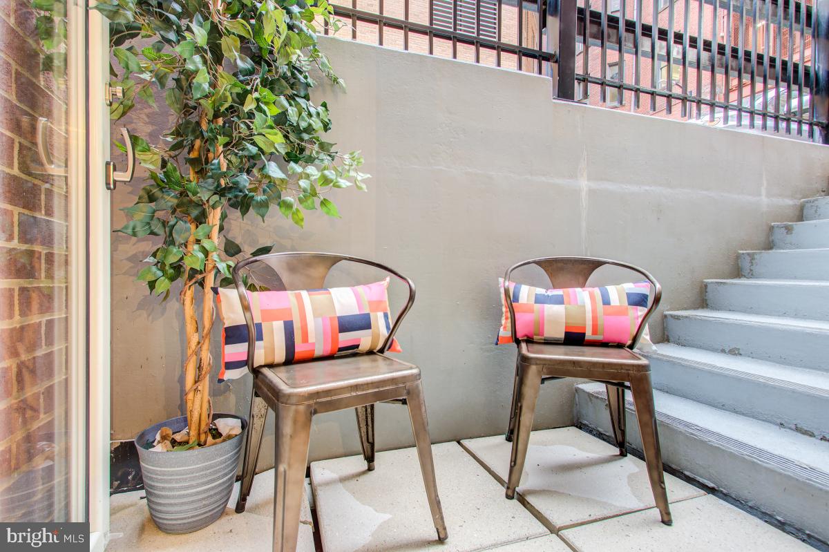 915 E Street Northwest, Unit 101 Washington, DC 20004 - Photo 23 of 34 a table with chairs and a potted plant