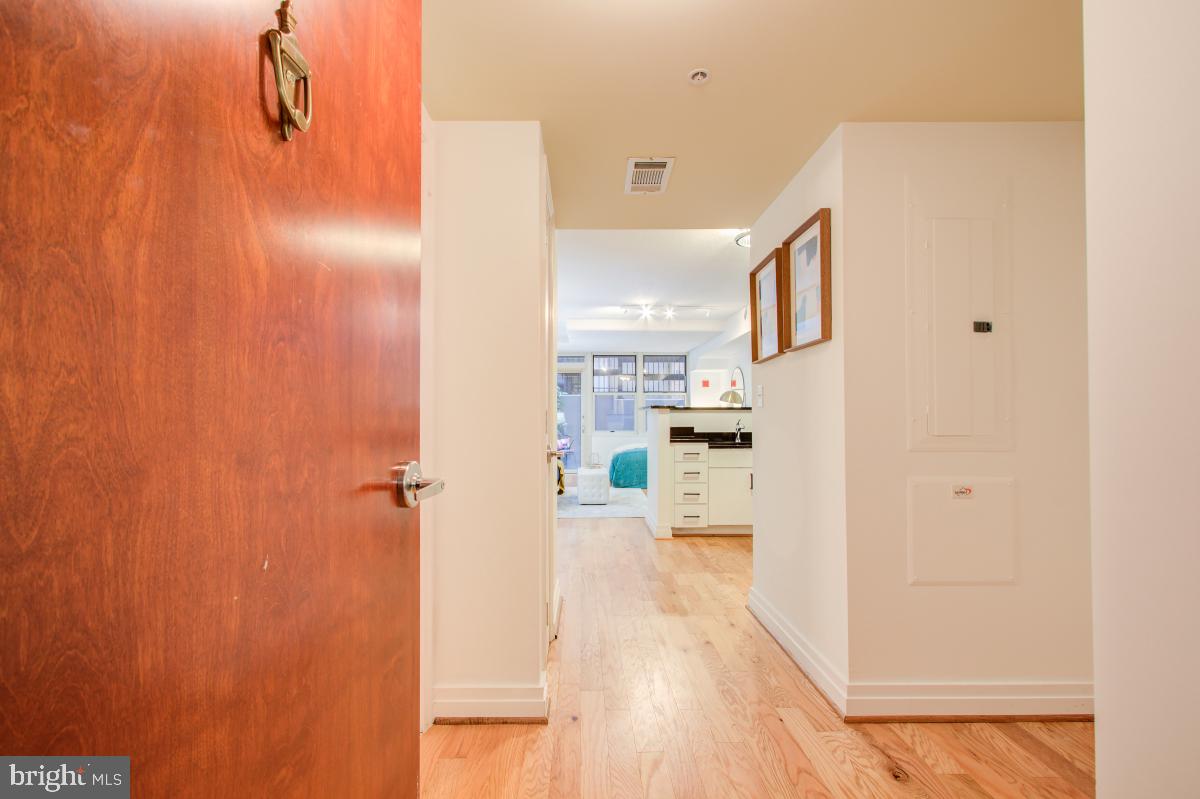 915 E Street Northwest, Unit 101 Washington, DC 20004 - Photo 6 of 34 a view of a kitchen from the hallway