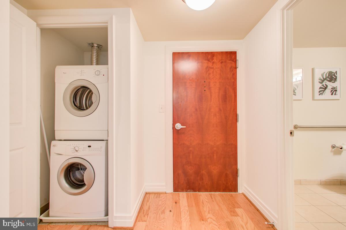 915 E Street Northwest, Unit 101 Washington, DC 20004 - Photo 7 of 34 a view of a hallway with washer and dryer