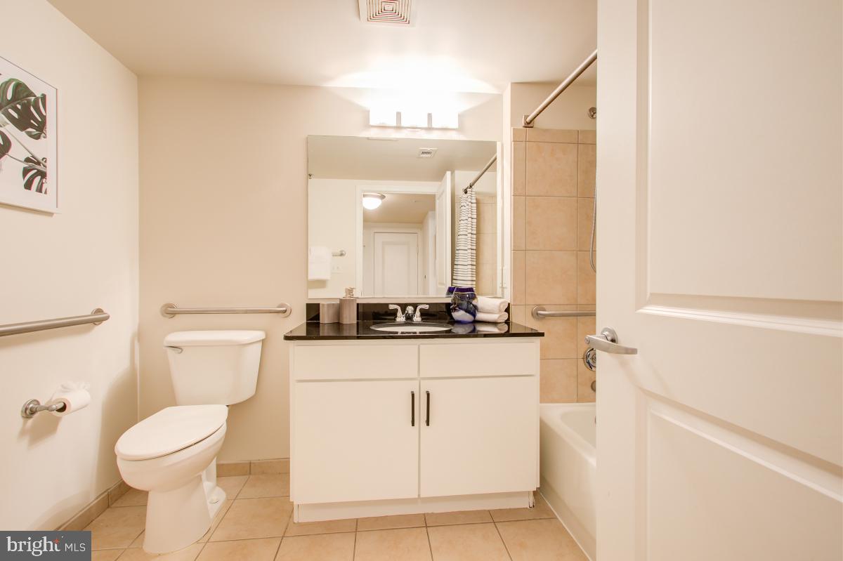 915 E Street Northwest, Unit 101 Washington, DC 20004 - Photo 8 of 34 a bathroom with a sink a toilet and a mirror