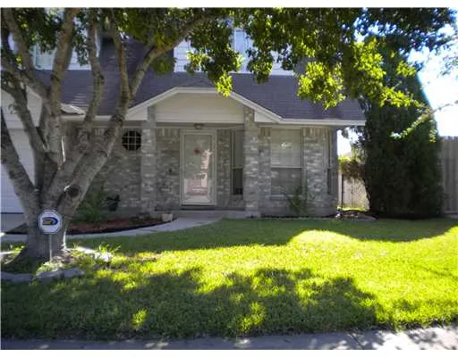 a view of a backyard with a garden and tree
