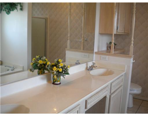4413 Silver Hollow Drive, Unit 1 Corpus Christi, TX 78413 - Photo 7 of 10 a bathroom with a sink a toilet and a mirror