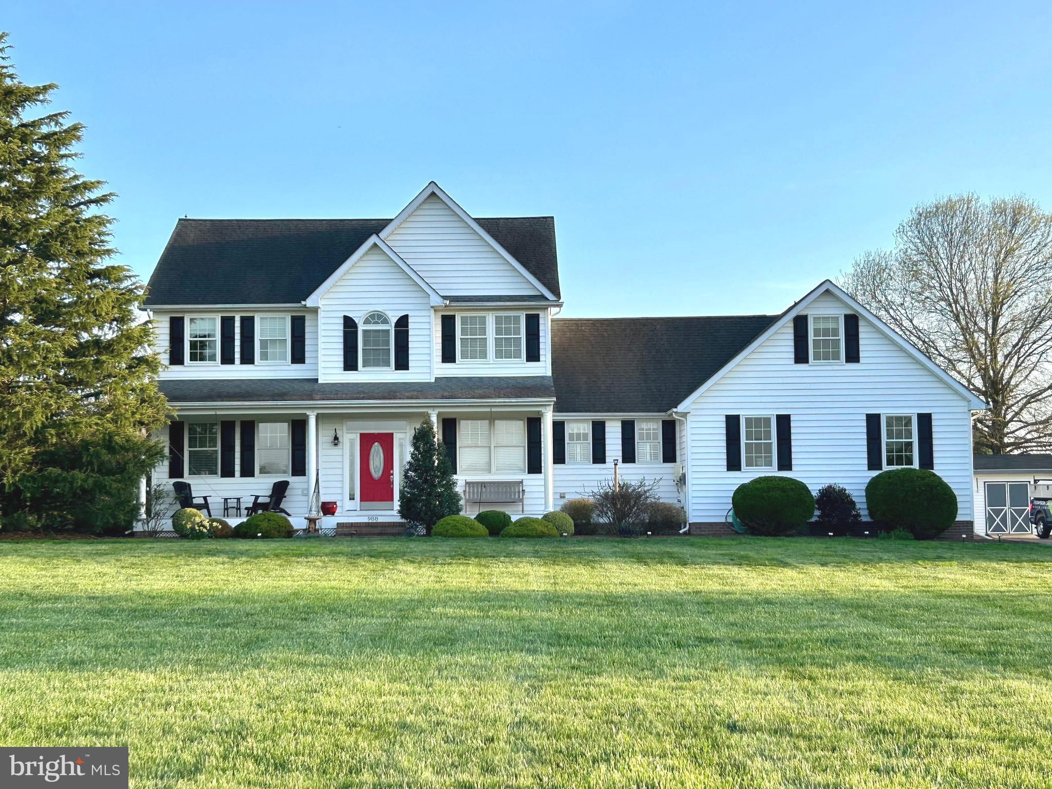 a front view of house with yard and green space