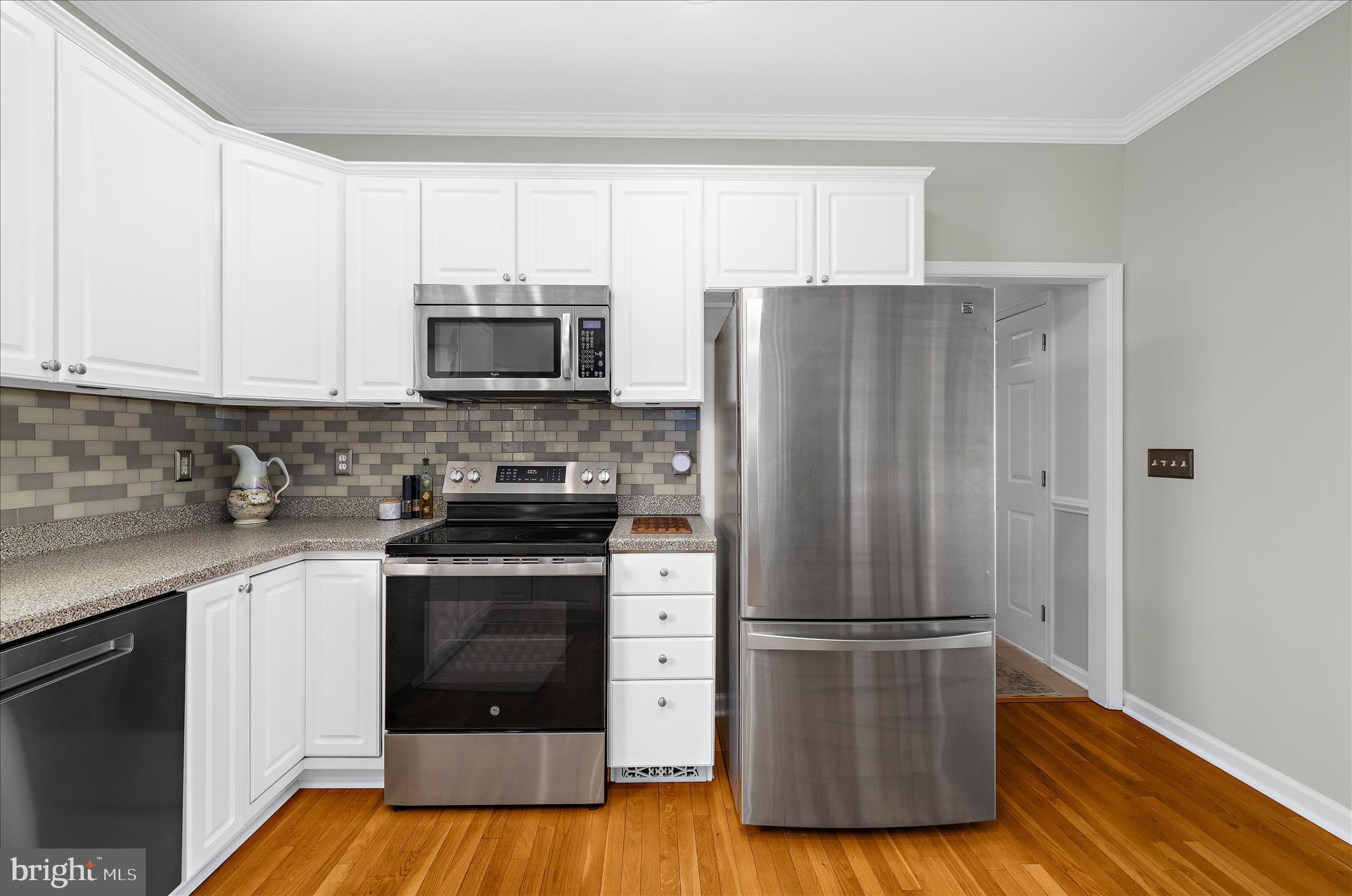 988 White Marsh Road Centreville, MD 21617 - Photo 15 of 96 a kitchen with a refrigerator stove and wooden cabinets