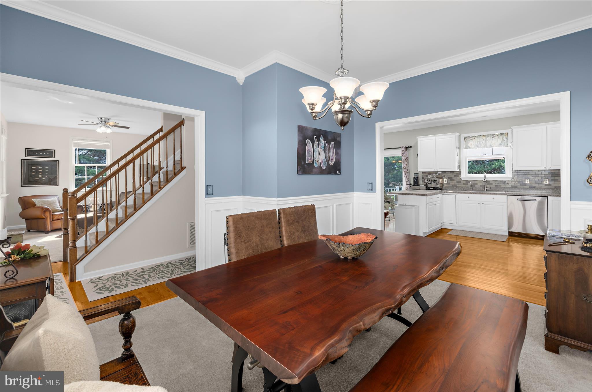 988 White Marsh Road Centreville, MD 21617 - Photo 30 of 96 a living room with dining table a table chairs and a chandelier