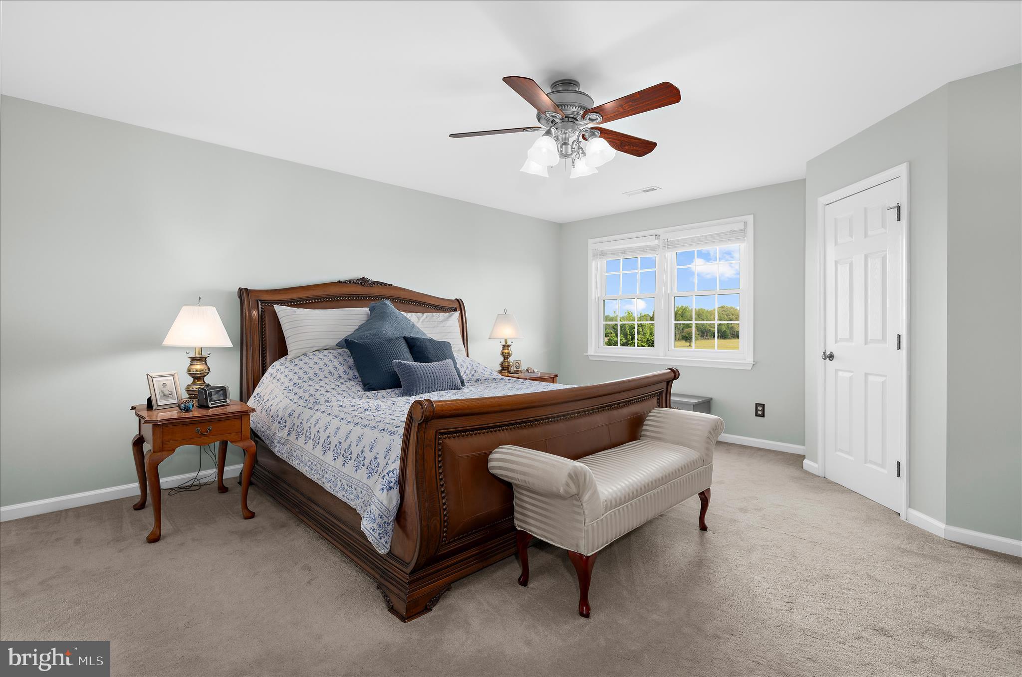988 White Marsh Road Centreville, MD 21617 - Photo 35 of 96 a bedroom with a bed and a chandelier