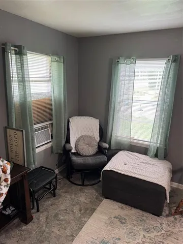 a bedroom with two beds and a window