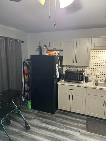 a kitchen with refrigerator and cabinets