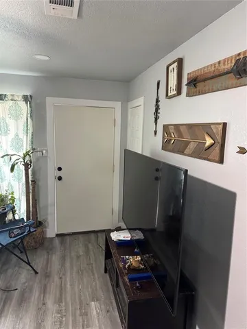 a room with wooden floor and furniture