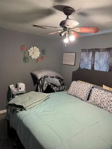 a bedroom with bed and window