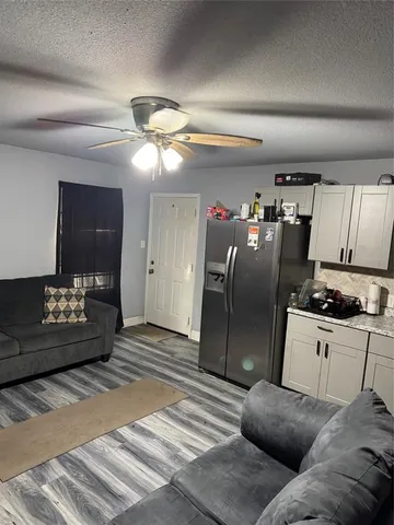a living room with a couch and a chandelier