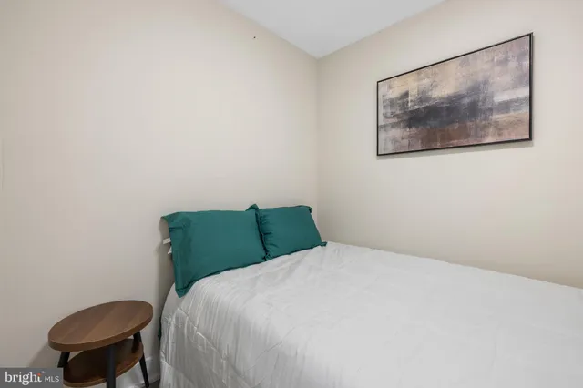 a bedroom with a bed and a chair