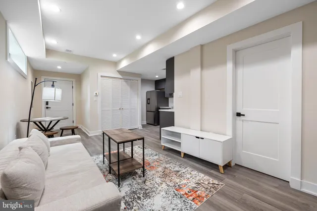 a living room with furniture and wooden floor