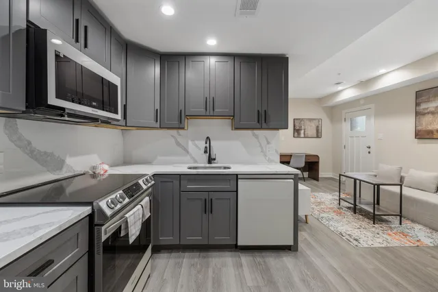a kitchen with a sink appliances and cabinets