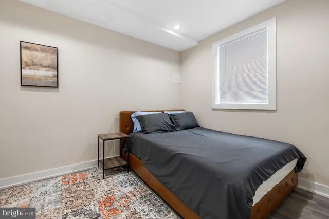 a bed sitting in a bedroom next to a window