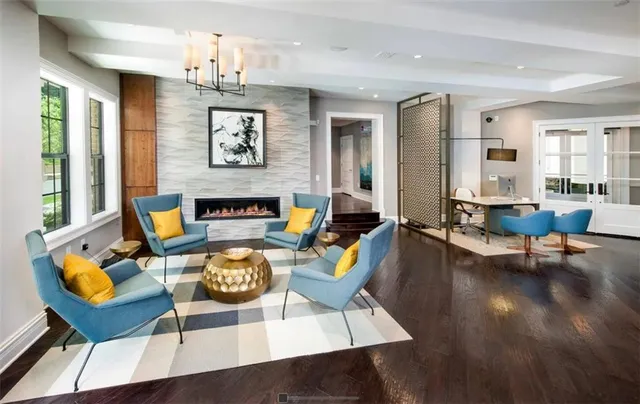a living room with furniture wooden floor and a fireplace