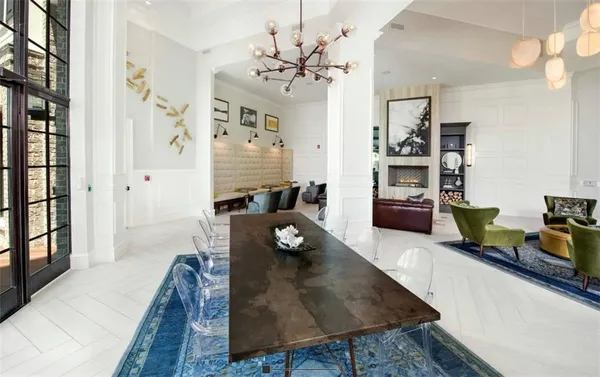 a living room with furniture a chandelier and a table