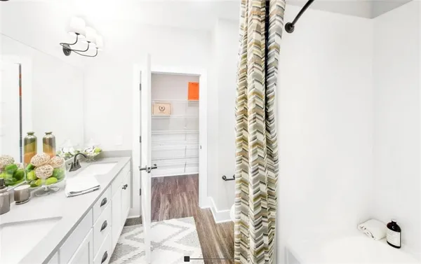 a bathroom with a bathtub sink and mirror