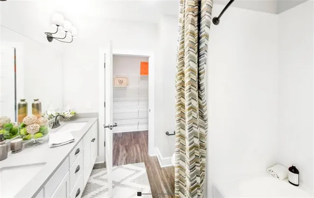 a bathroom with a bathtub sink and mirror