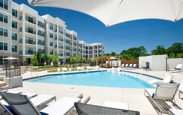 a view of a swimming pool with outdoor seating