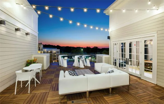 a balcony with furniture and a potted plant