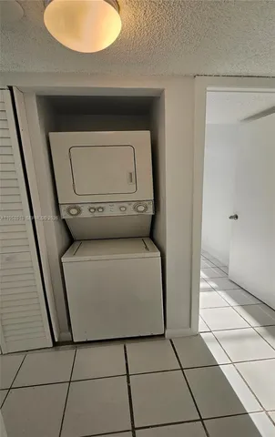 a bathroom with a granite countertop toilet and a shower