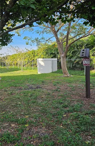 a swimming pool with outdoor seating and yard