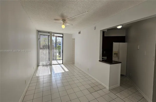 an empty room with wooden floor and mirror