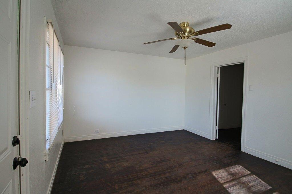 1805 Avenue R Lubbock, TX 79401 - Photo 12 of 18 an empty room with wooden floor closet and windows