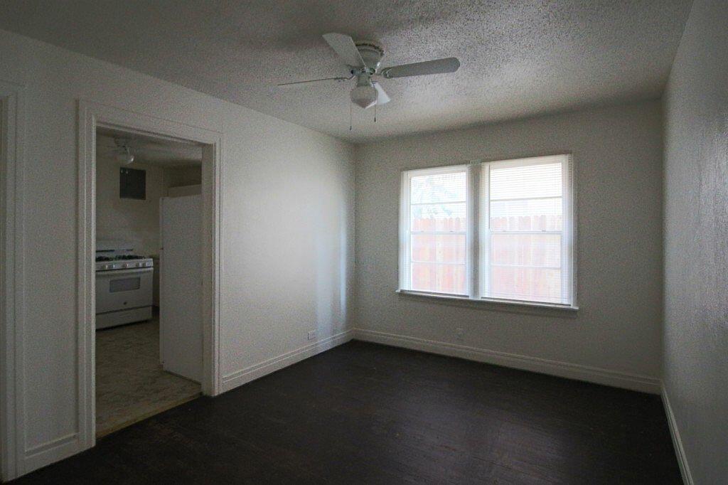 1805 Avenue R Lubbock, TX 79401 - Photo 14 of 18 an empty room with a window and a ceiling fan