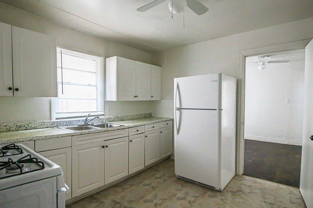 1805 Avenue R Lubbock, TX 79401 - Photo 16 of 18 a kitchen with a white cabinets and refrigerator