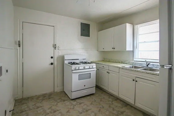 a kitchen with sink cabinets and window
